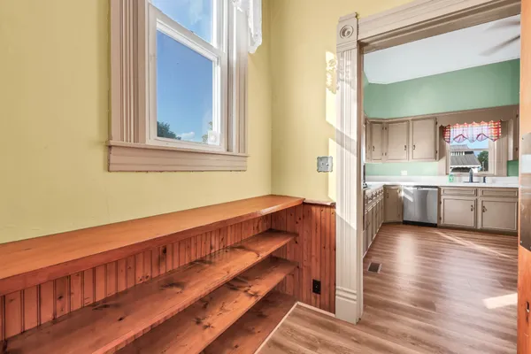 a view of an empty room with a fireplace and a window