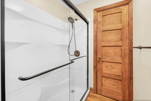 an empty room with wooden floor and closet