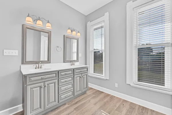 a view of a livingroom with a chandelier fan and a window