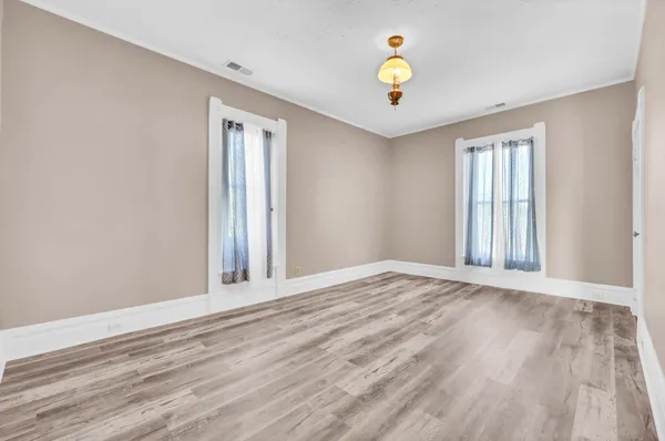 a living room with a table and a pool table and chairs