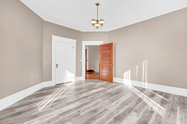 a view of a room with wooden floor and staircase
