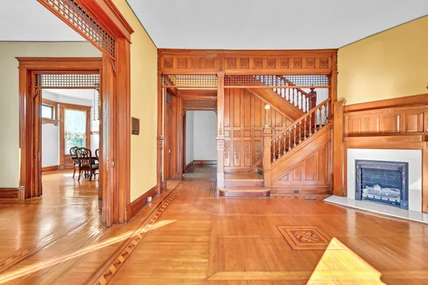 a view of a livingroom with a fireplace dining space and windows