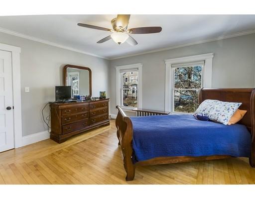 22 Berkeley Street Somerville, MA 02143 - Photo 14 of 28 a bedroom with a bed and a chandelier