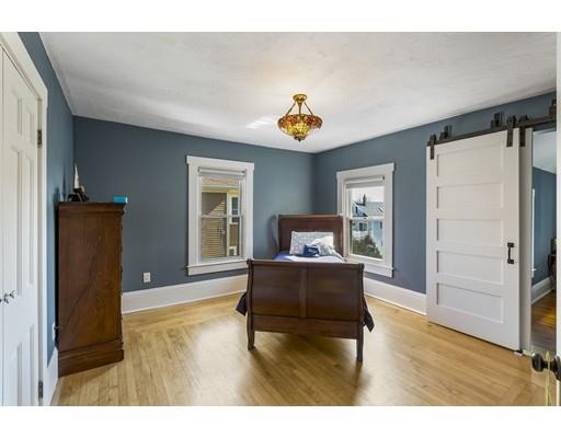 22 Berkeley Street Somerville, MA 02143 - Photo 16 of 28 a living room with furniture and a wooden floor