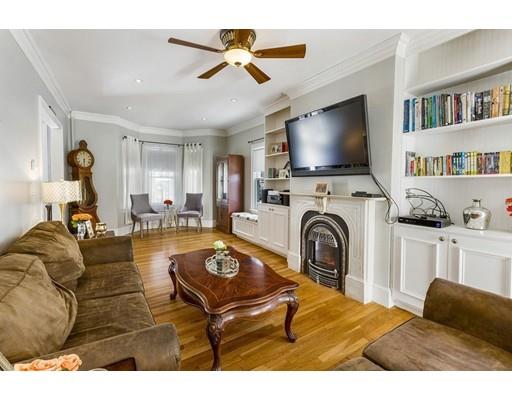 22 Berkeley Street Somerville, MA 02143 - Photo 7 of 28 a living room with furniture flat screen tv and a fireplace