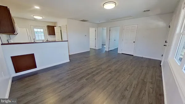 a view of a room with wooden floor and cabinet