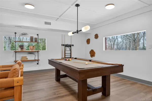 a view of a workspace with furniture and wooden floor