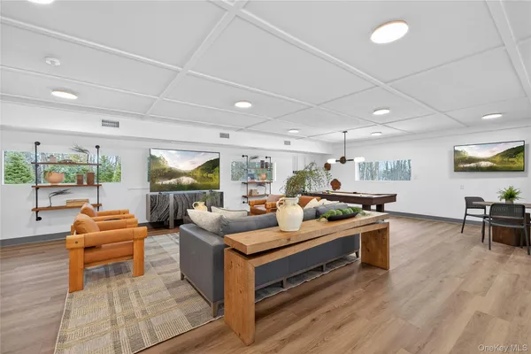 a living room with furniture kitchen view and a large window