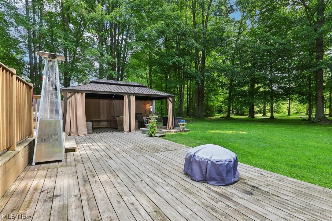 3213 Bates Road Madison, OH 44057 - Photo 36 of 45 Spacious wood-finish deck with a built-in gazebo and privacy curtains