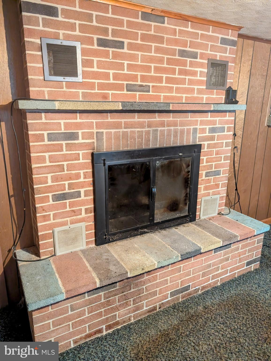 12706 High Point Road Felton, PA 17322 - Photo 15 of 56 a living room with a fireplace wooden floor and a fireplace