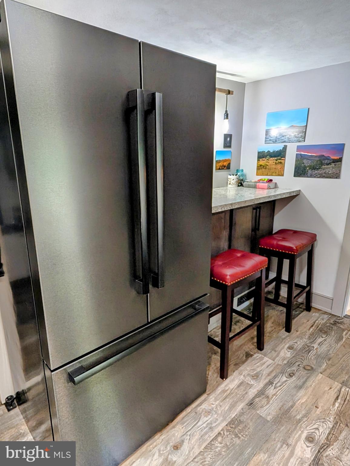 12706 High Point Road Felton, PA 17322 - Photo 32 of 56 a kitchen with stainless steel appliances refrigerator stove dining table and chairs