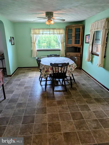 a view of a dining room with furniture and a window