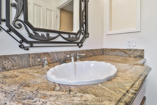a kitchen with stainless steel appliances granite countertop wooden floors and white cabinets