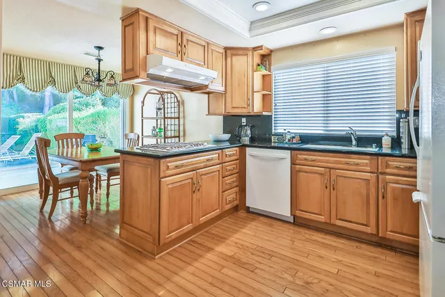 a kitchen with stainless steel appliances granite countertop a refrigerator sink and cabinets