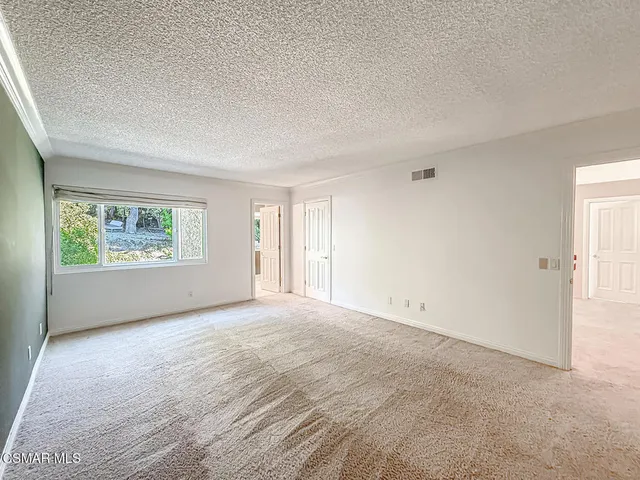 a bedroom with a bed lamp and a window