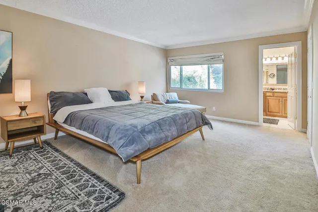 a bedroom with a bed and windows