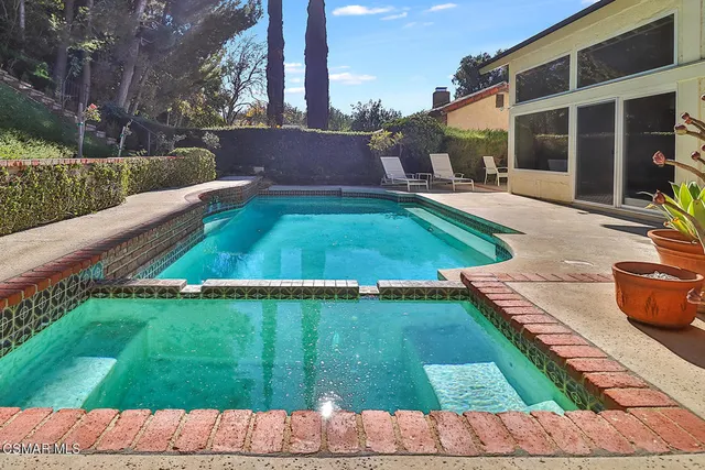 a view of a patio with table and chairs potted plants with palm trees