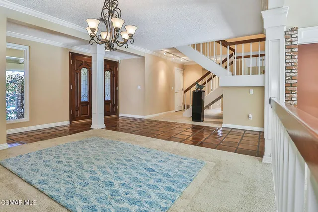 wooden floor with a chandelier