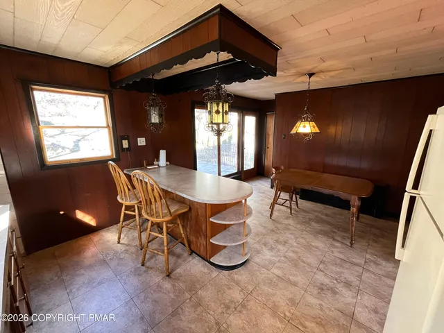 a view of a dining room with furniture and window