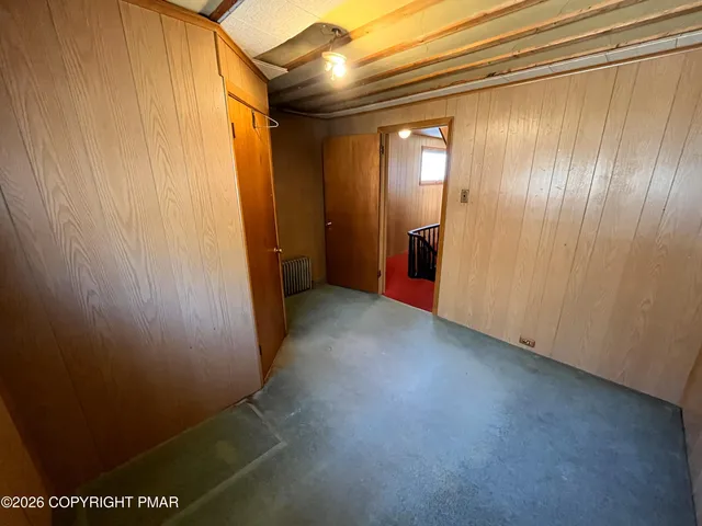 a big room with closet and windows