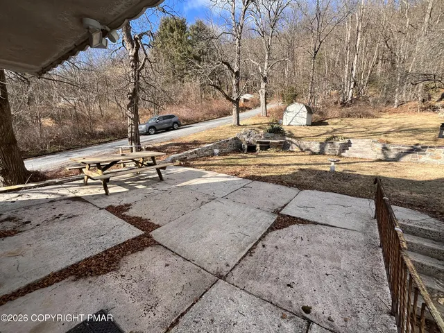 a view of a house with backyard and sitting area