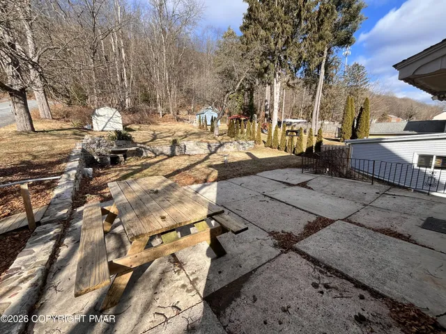 a view of a yard with cars