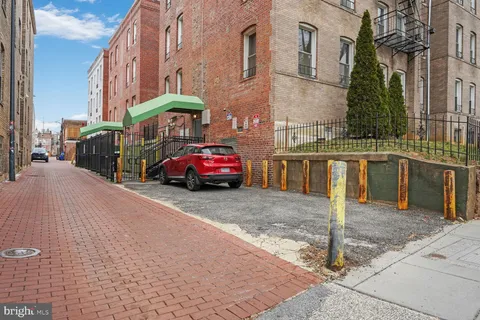 a car parked in front of brick building