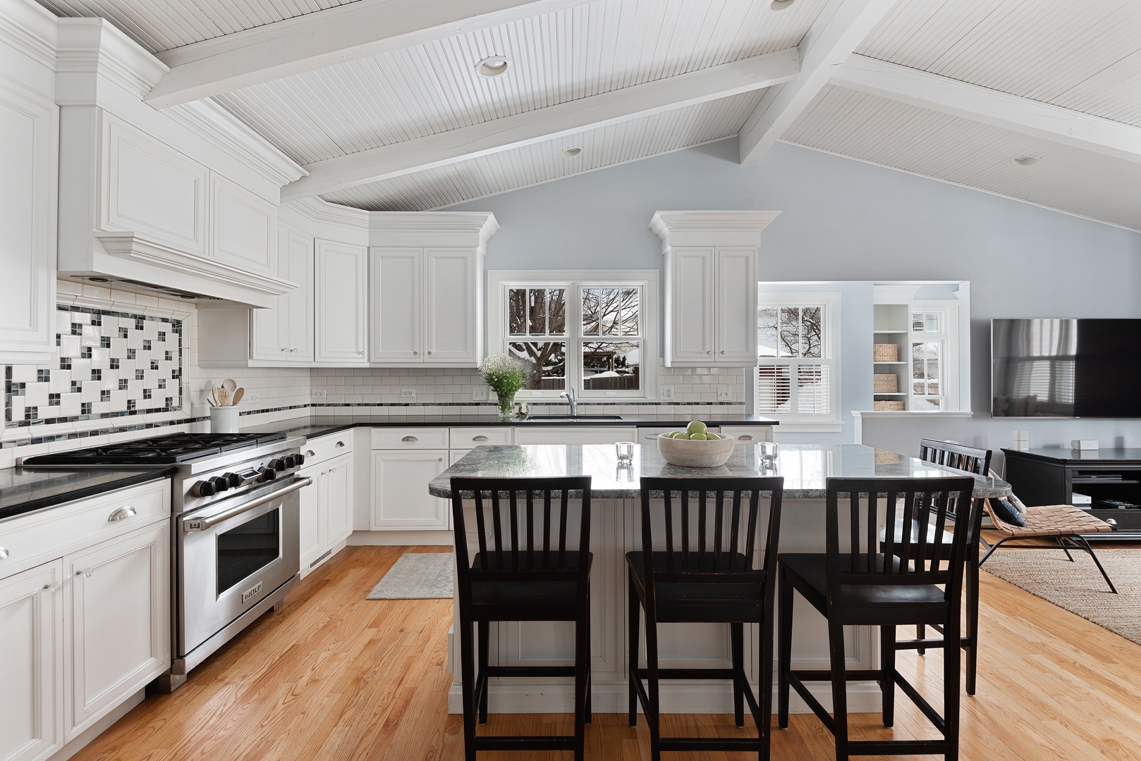 969 Willow Road Winnetka, IL 60093 - Photo 8 of 33 a kitchen with a dining table chairs and white cabinets