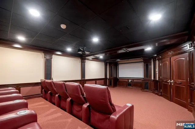 a dining room with wooden floor and chandelier