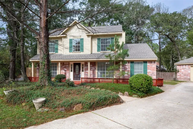 a front view of a house with a yard and trees