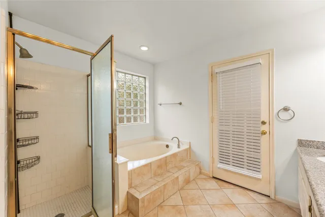 a view of an empty room with chandelier fan and wooden floor