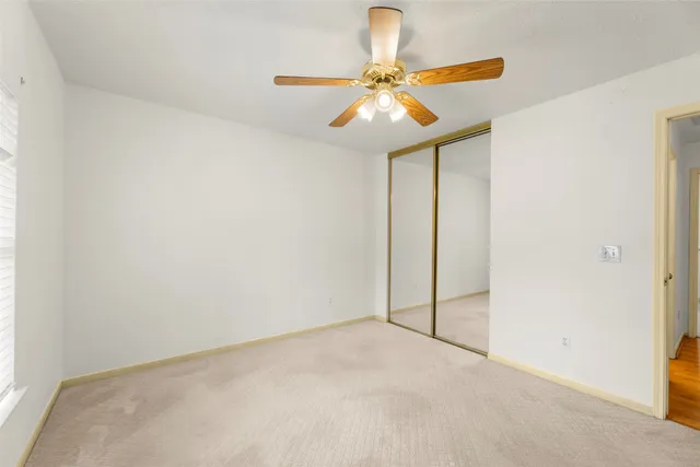 a view of a chandelier fan and entryway