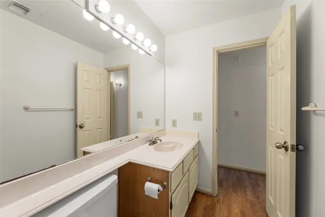 a view of a house with a yard and large trees