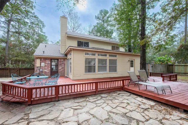 a view of balcony with wooden floor and fence