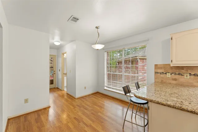 a view of a room with wooden floor and windows