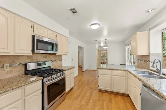 a view of kitchen with sink microwave refrigerator and outdoor view