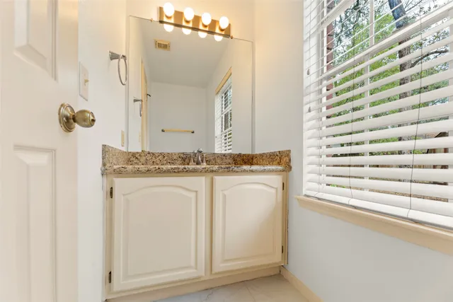 wooden floor fireplace and windows in an empty room