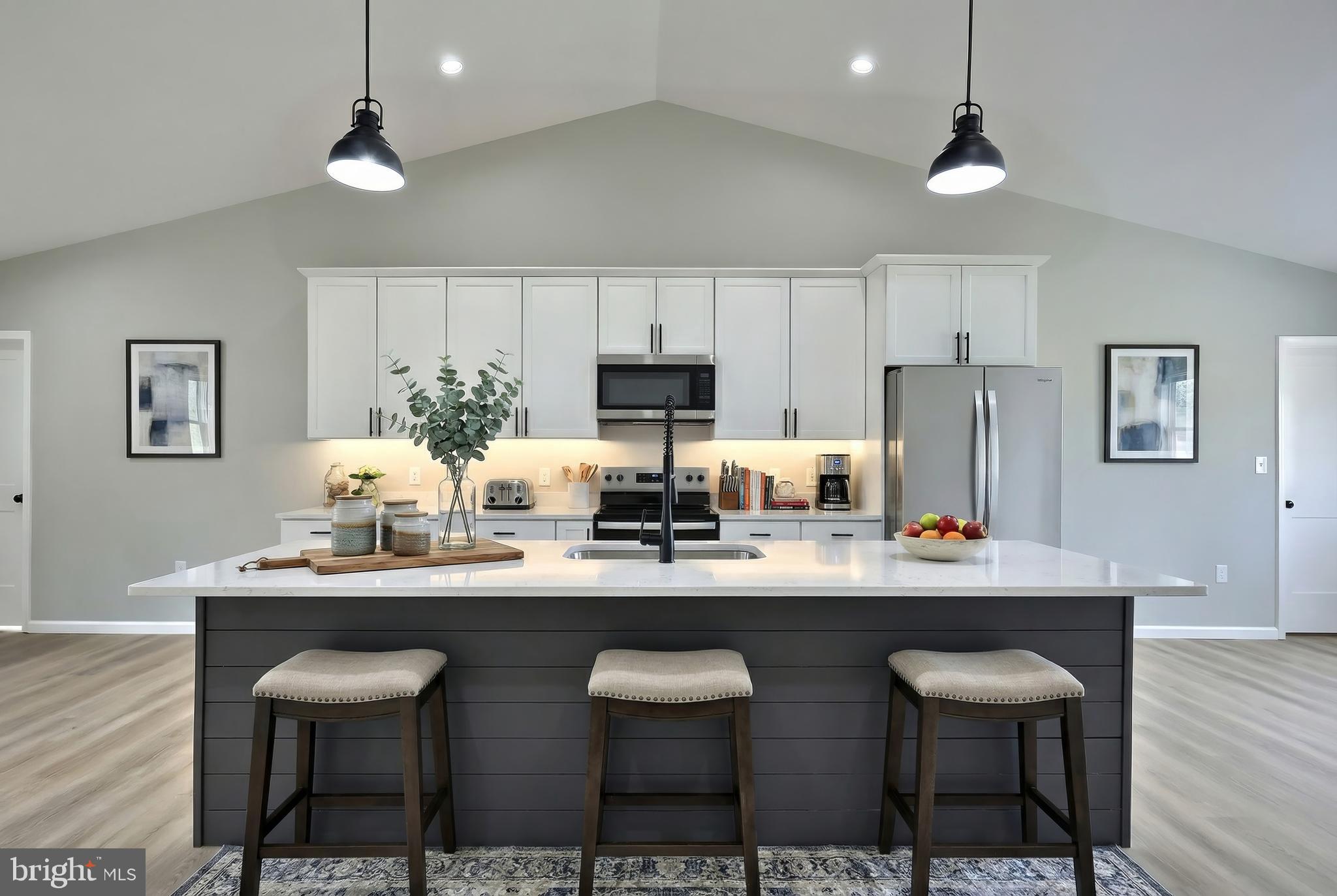 10620 Enfield Road Felton, PA 17322 - Photo 21 of 62 a kitchen with stainless steel appliances a dining table and chairs with wooden floor