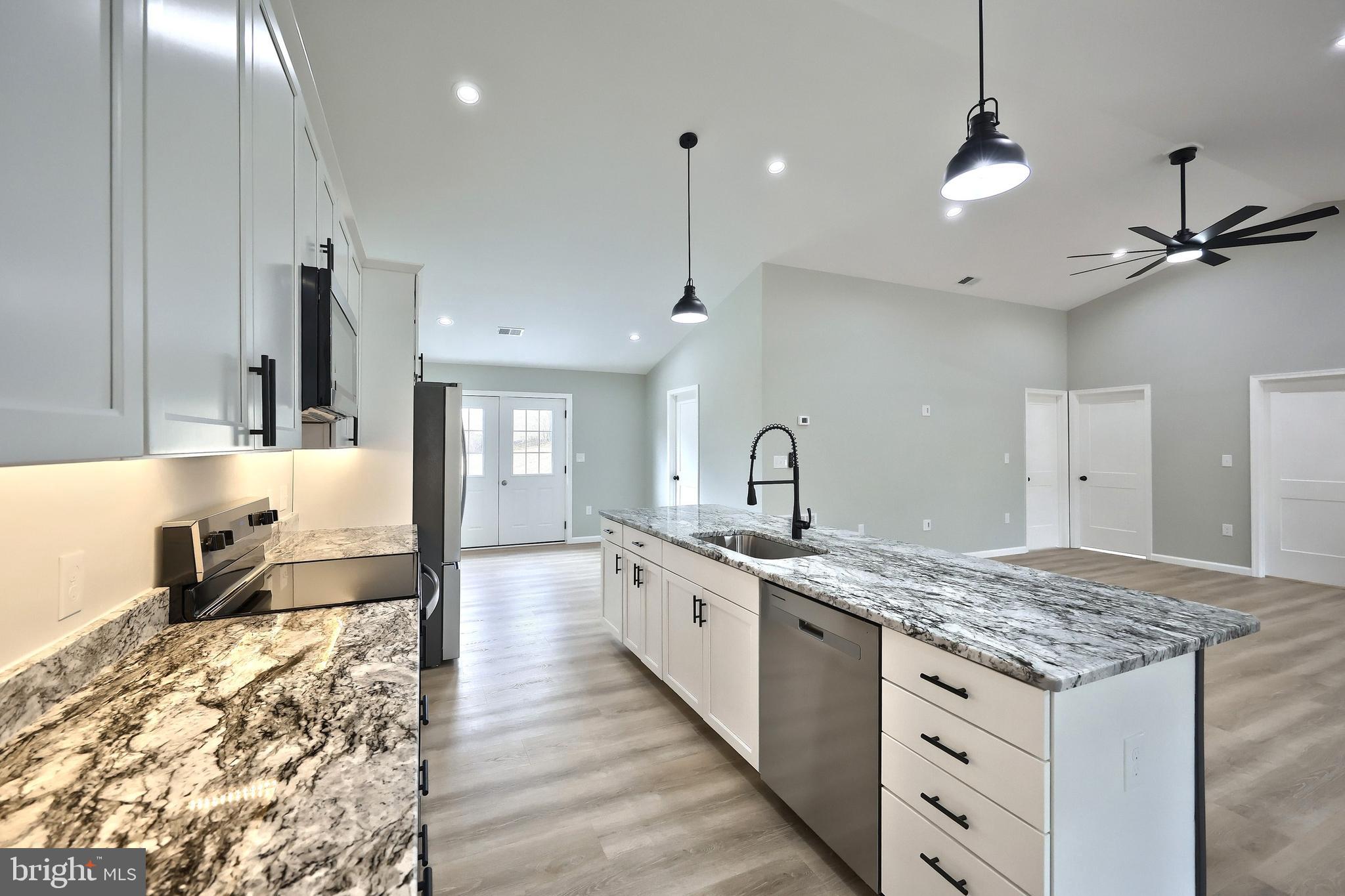 10620 Enfield Road Felton, PA 17322 - Photo 23 of 62 a large kitchen with kitchen island a sink stainless steel appliances and cabinets