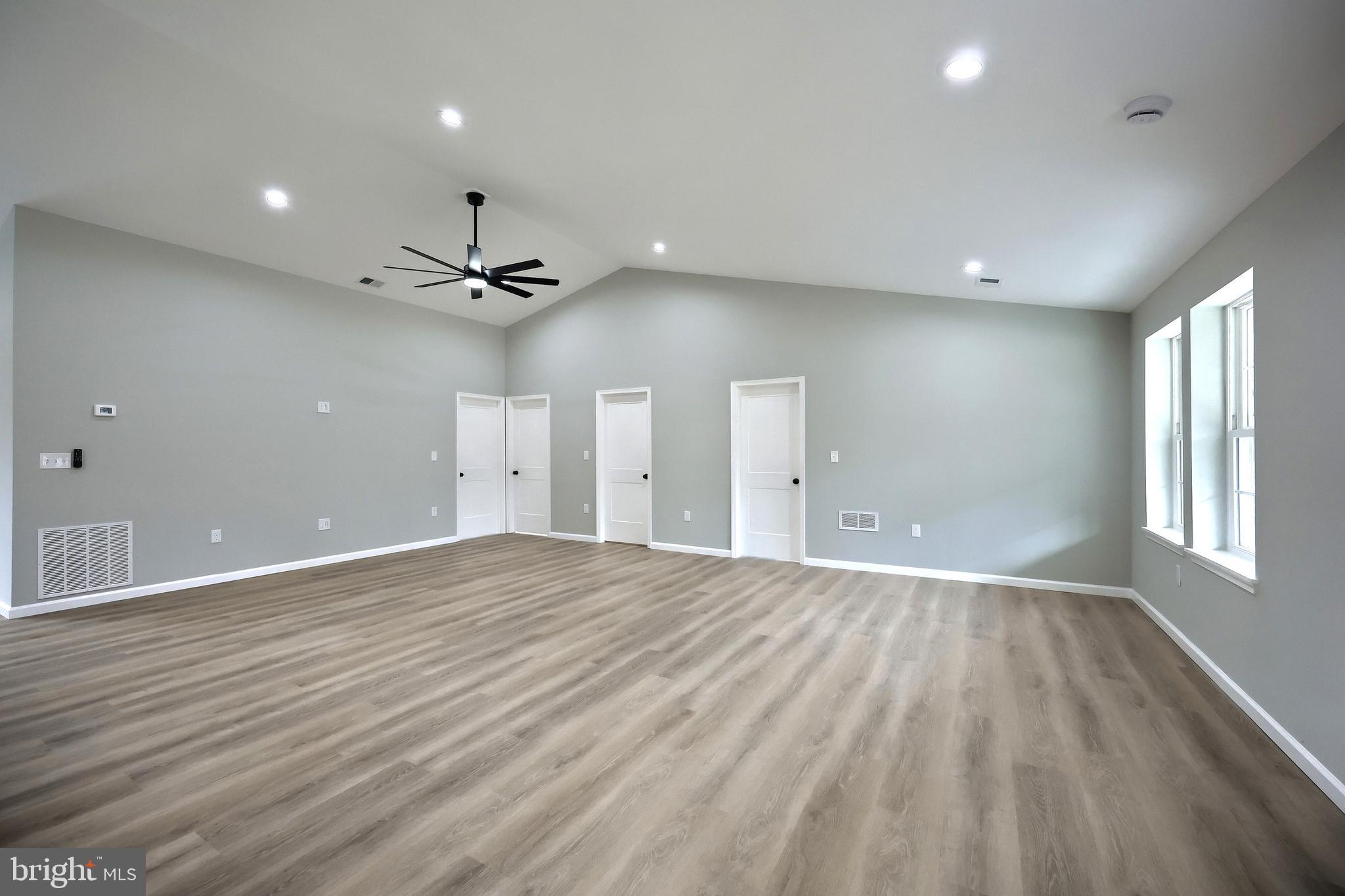 10620 Enfield Road Felton, PA 17322 - Photo 26 of 62 an empty room with wooden floor and windows