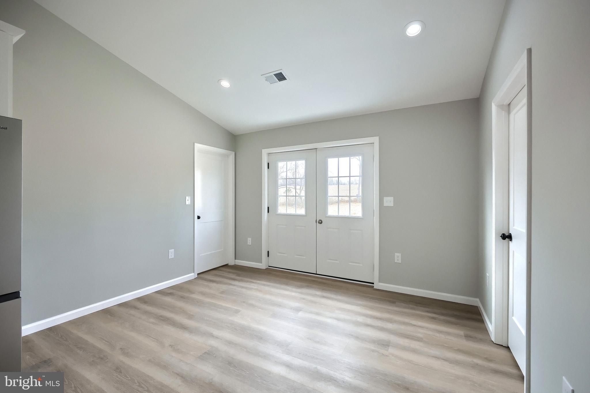 10620 Enfield Road Felton, PA 17322 - Photo 30 of 62 a view of an empty room with wooden floor and a window