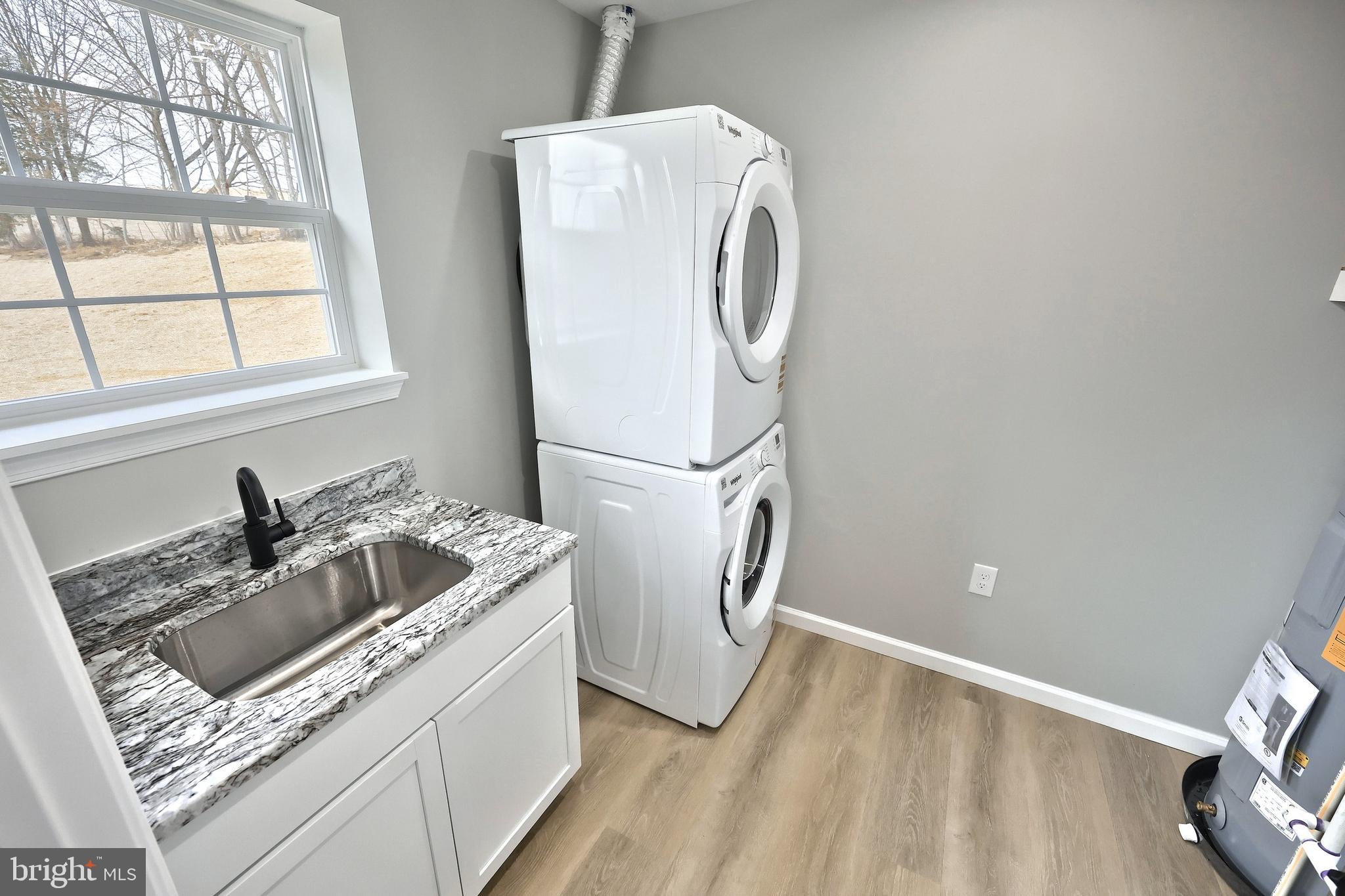10620 Enfield Road Felton, PA 17322 - Photo 32 of 62 a kitchen with a sink a refrigerator and washer