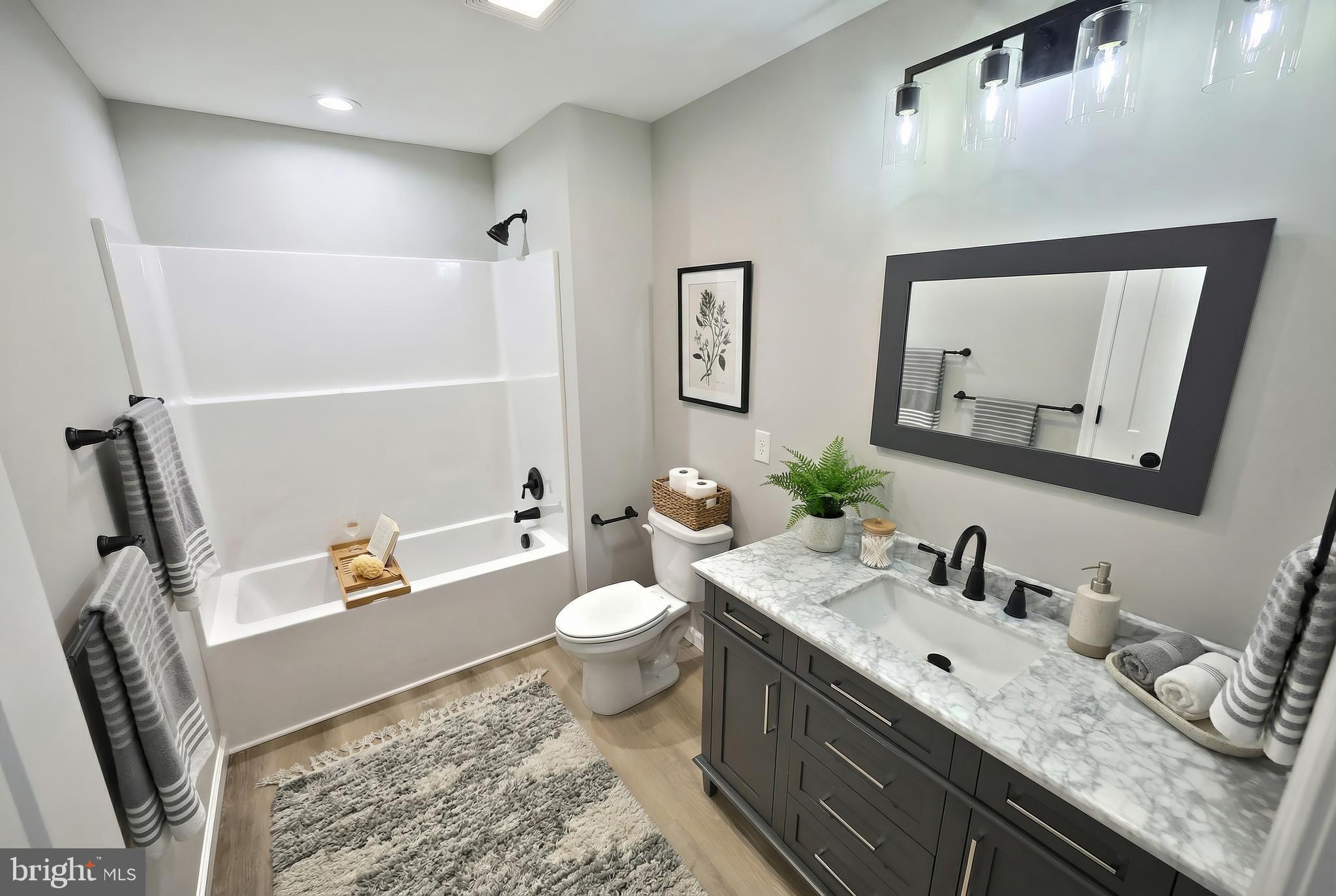 10620 Enfield Road Felton, PA 17322 - Photo 40 of 62 a bathroom with a granite countertop sink mirror vanity and toilet