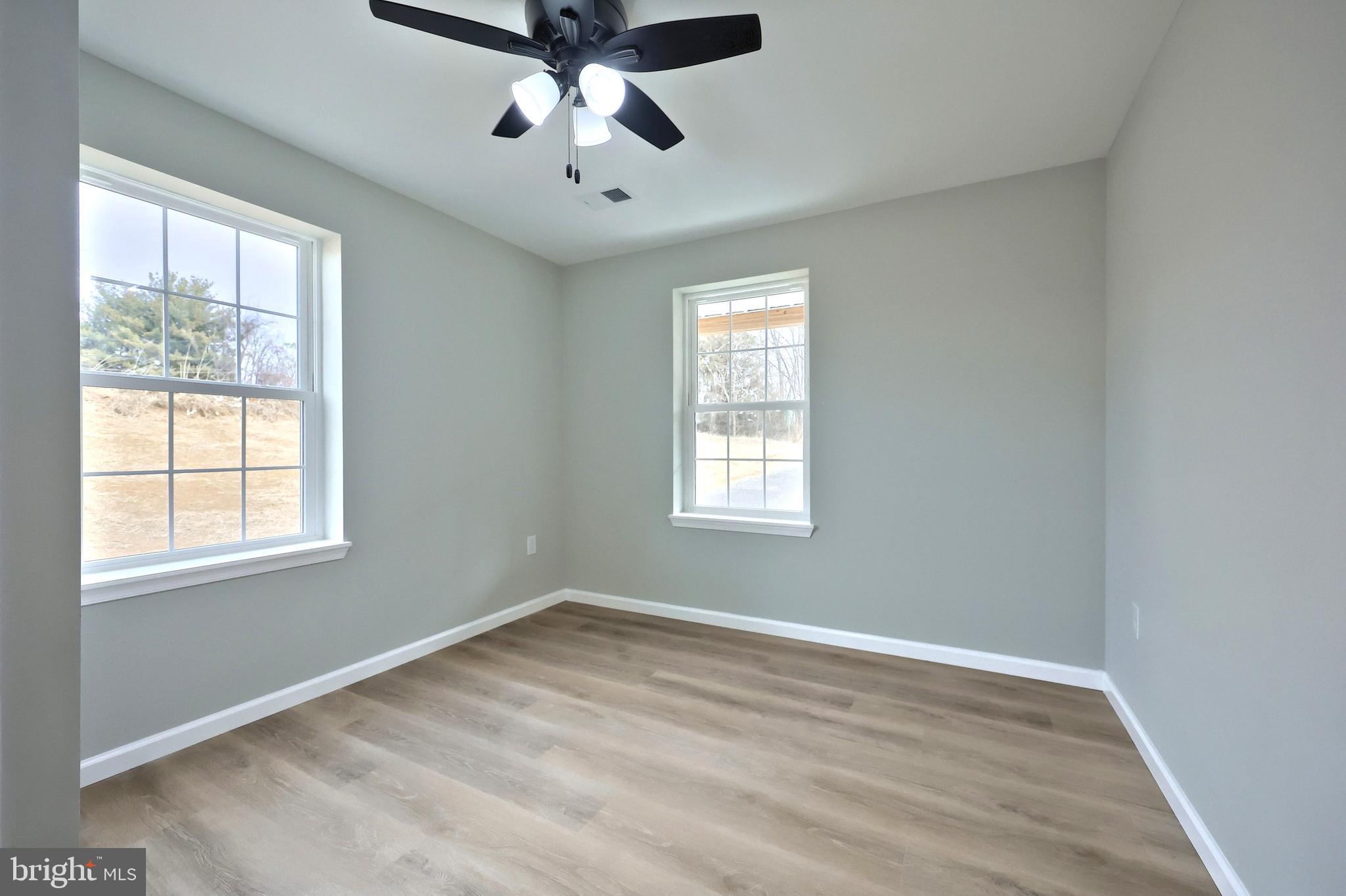 10620 Enfield Road Felton, PA 17322 - Photo 42 of 62 a view of empty room with wooden floor and fan
