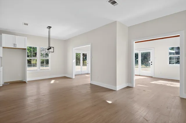a view of a kitchen with wooden floor and a window