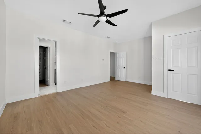 a view of empty room with wooden floor