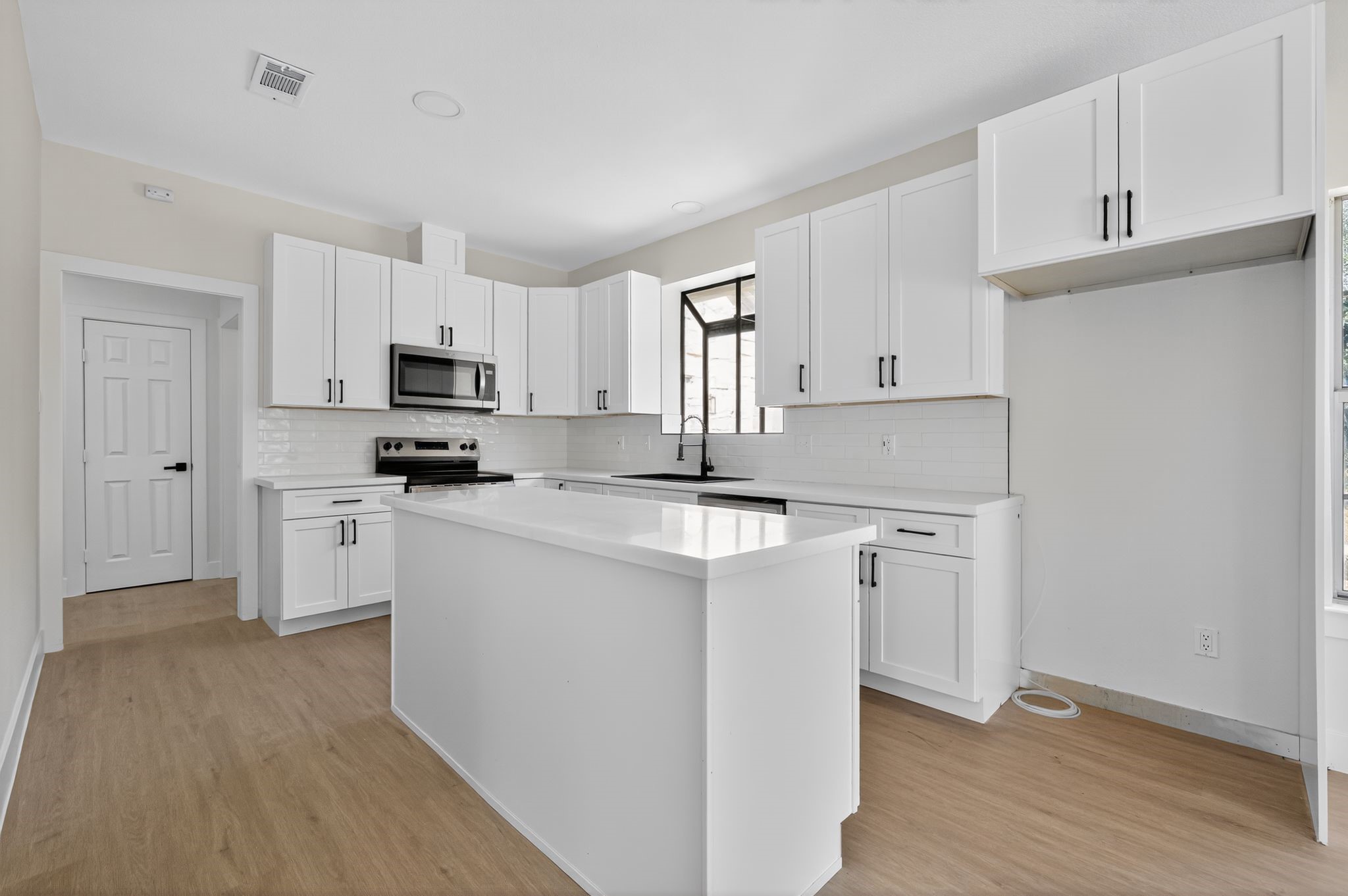 300 Fawn Lane Georgetown, TX 78628 - Photo 30 of 43 a kitchen with white cabinets and white appliances