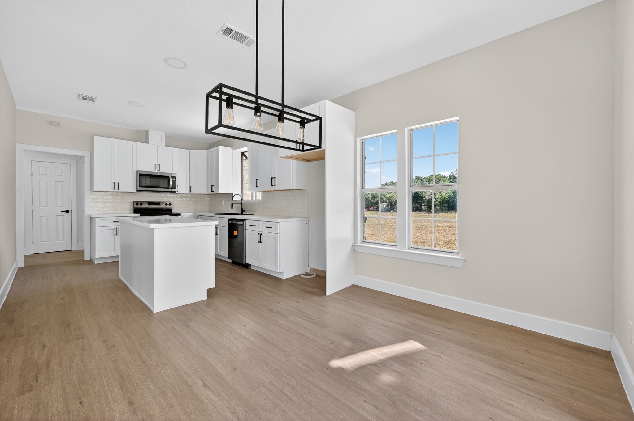 300 Fawn Lane Georgetown, TX 78628 - Photo 33 of 43 a kitchen with stainless steel appliances a stove top oven a sink a refrigerator a window and white cabinets
