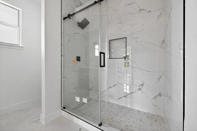 a bathroom with a glass shower door