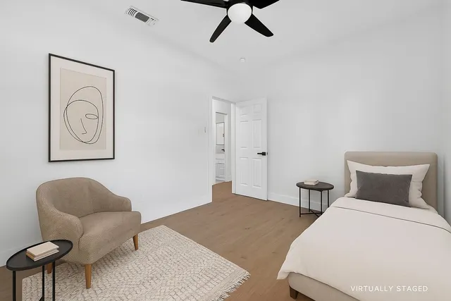 a bedroom with a bed and chair